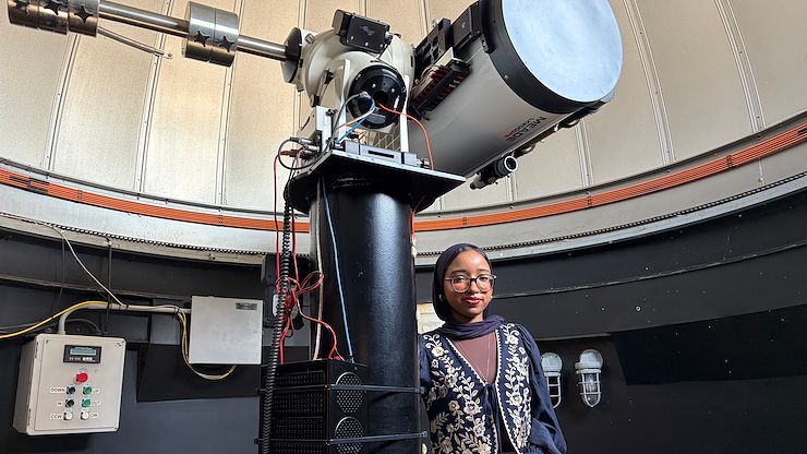 Loujain Ahmed, the Montgomery County Community College 2026 Commencement student speaker, stands in the observatory on the Blue Bell Campus. Photo by Eric Devlin