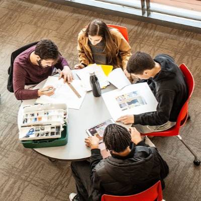 Overhead shot of students sitting at a table studying