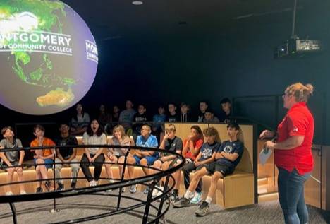 Students observing the Science on a Sphere exhibit