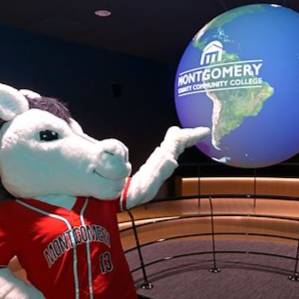 Monty posing with the Science on a Sphere exhibit