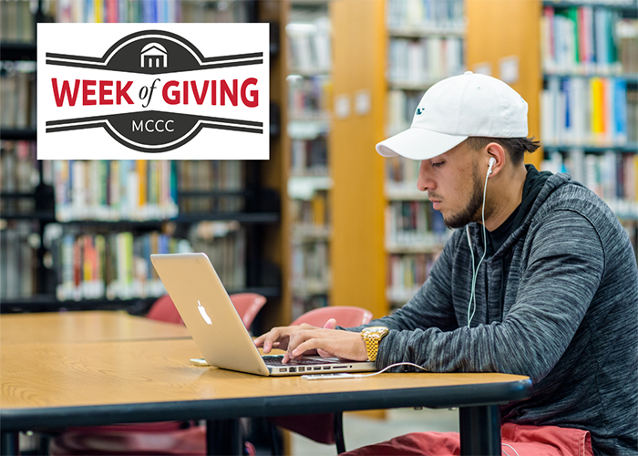 Students working on laptops in library