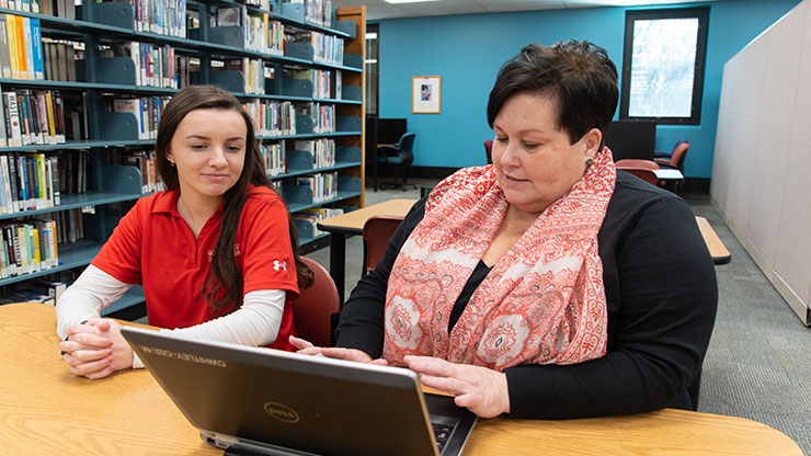 MCCC Financial Aid & Enrollment Generalist Cindy Whitley assists an MCCC student. Photo by Linda Johnson