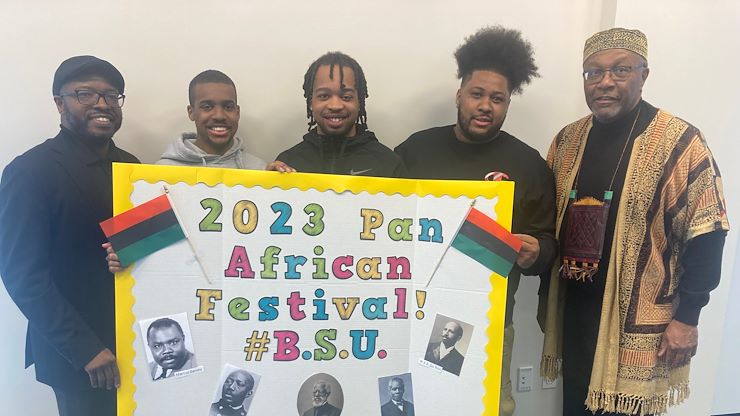 Members of the Black Student Union hold up a poster during the Pan African Festival. The celebration included discussion about the Black experience and those in attendance were able to sample different styles of barbecue. Photos by Eric Devlin.