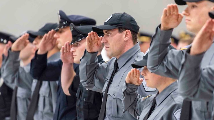 Cadets in the Montgomery County Community College Municipal Police Academy Class 2301 stand saluting at attention during their graduation ceremony. The ceremony celebrated the 28 graduates in the Health Sciences Center gymnasium on Blue Bell Campus. Photos by Linda Johnson.