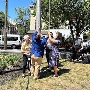 Dr. Isabelle Porter raises the Pride Flag