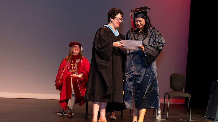 graduate receives award from Program Manager Michelle Kulla