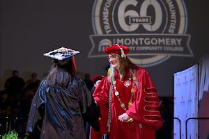 President Bastecki-Perez shaking graduate's hand President Bastecki-Perez shaking graduate's hand