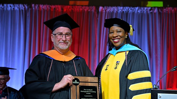 Physics Instructor Douglas Vardakas stands with Dr. Chae Sweet, Vice President of Academic Affairs and Provost at Commencement. Vardakas was named the 2024 recipient of the Lindback Distinguished Teaching Award. Photo by Dave DeBalko