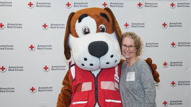 Nursing alumna Randy Miller poses with American Red Cross mascot, Fred Cross, during an event. Miller has been helping the community for more than four decades. Photos courtesy of American Red Cross