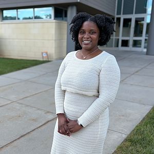 Anthonesha Anguin stands in front of the Health Sciences Center outside on the Blue Bell Campus. 